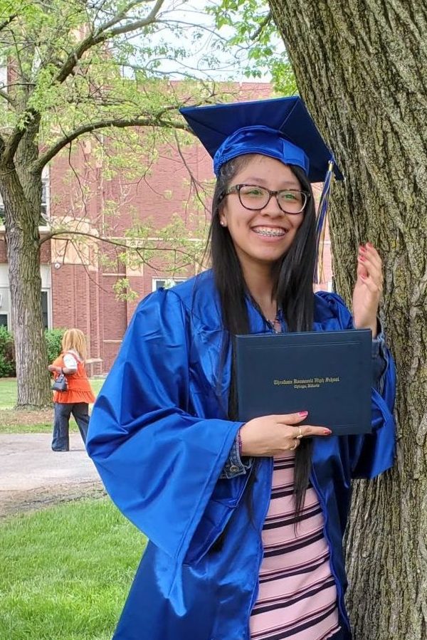 single student hs graduation with diploma outdoors